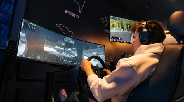 Driver using a racing simulator at TAG E-Karting
