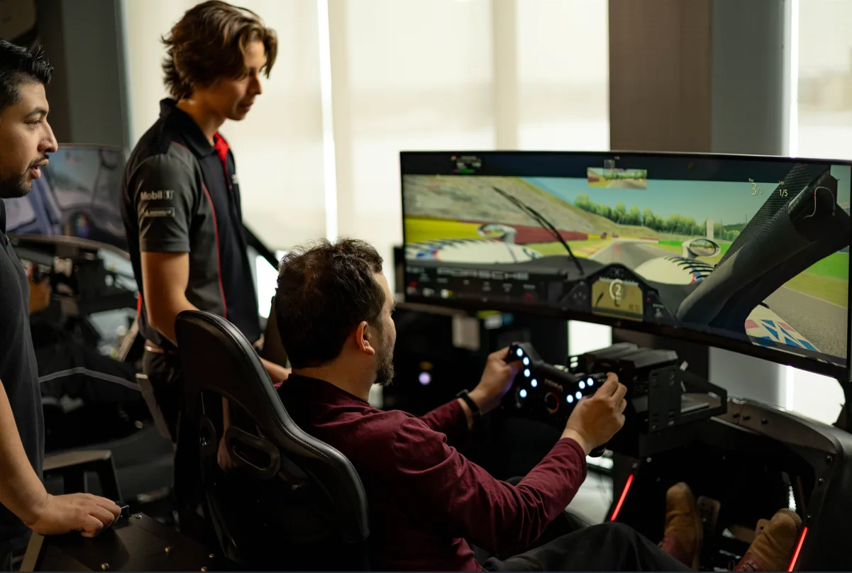 Driver and instructors in the Porsche Experience Centre Toronto Sim Lab
