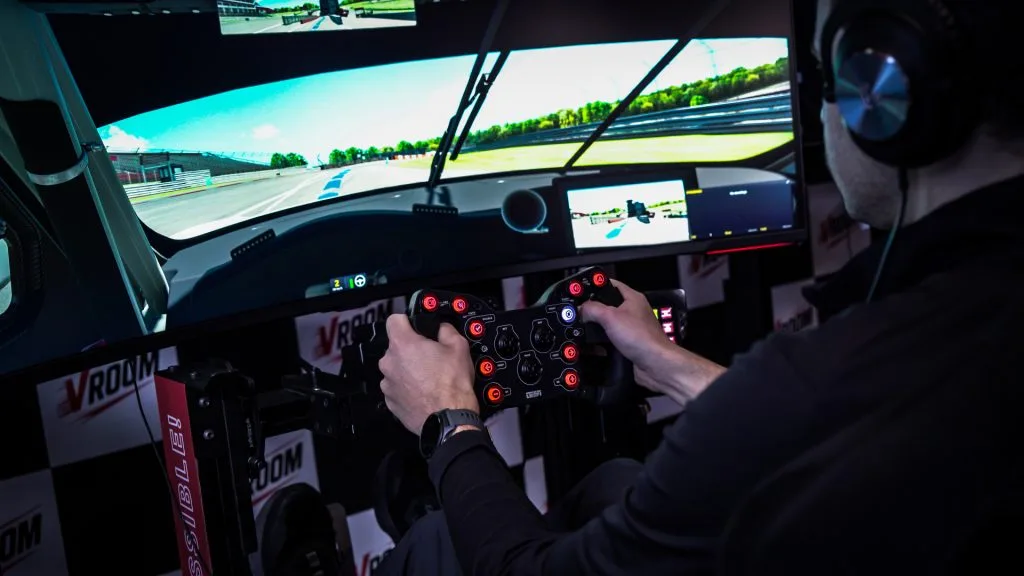 Driver using a racing simulator at Vroom DIX30