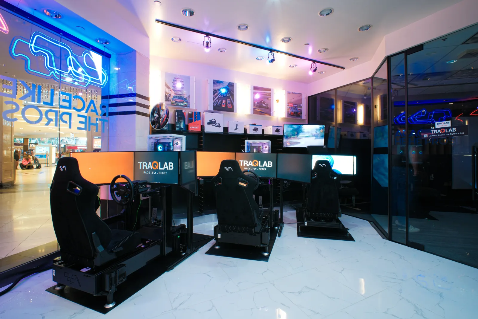 Racing cockpits and monitors inside the TraqLab venue.