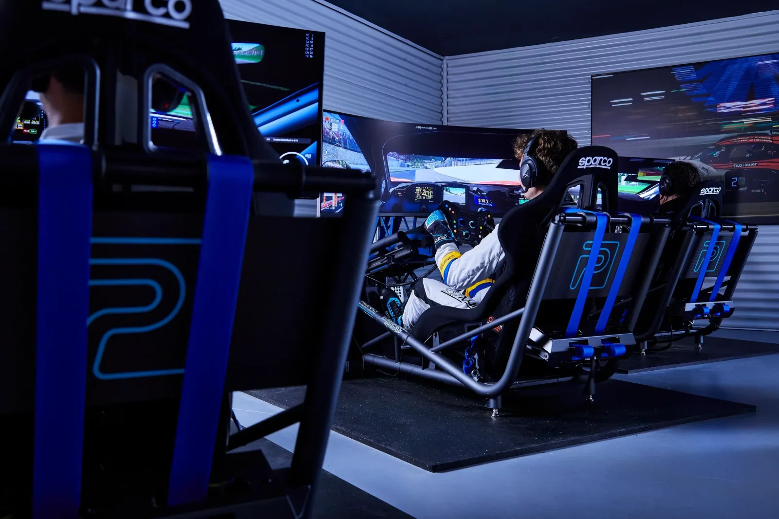 Blue-lit simulator room at The Paddock Motorsport Simulation