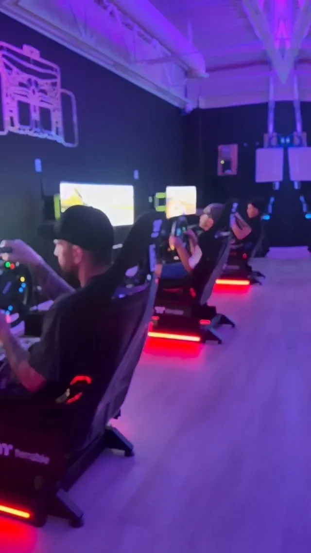 Drivers using the simulator row at First Last Sim Lounge