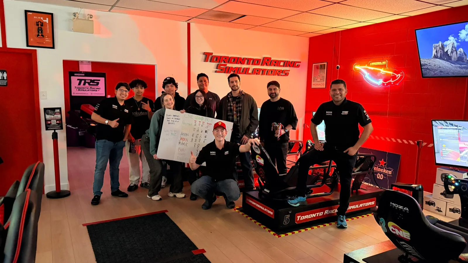 Group beside the simulators at Toronto Racing Simulators